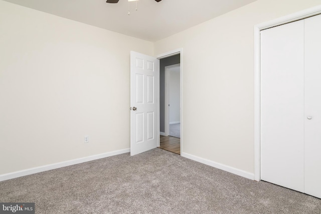 unfurnished bedroom with a closet, light colored carpet, and ceiling fan