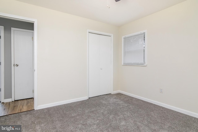 unfurnished bedroom featuring carpet flooring and a closet