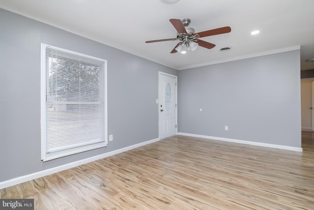 unfurnished room featuring light hardwood / wood-style floors, ceiling fan, and crown molding