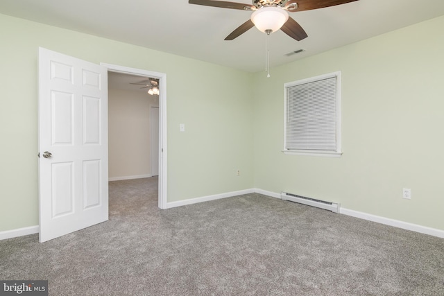 carpeted spare room featuring baseboard heating and ceiling fan