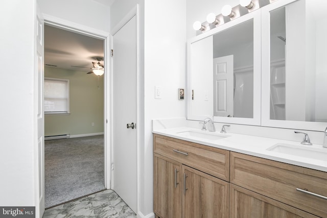 bathroom with ceiling fan, vanity, and a baseboard heating unit