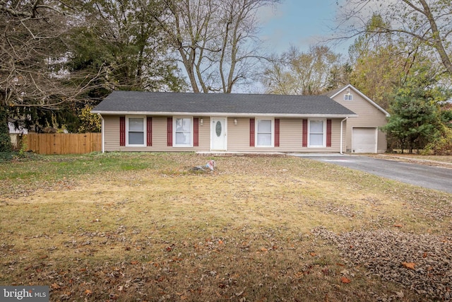 single story home with a front yard and a garage