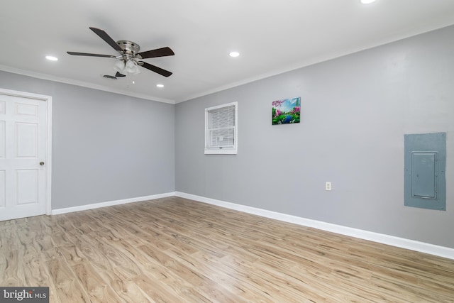 unfurnished room with ceiling fan, ornamental molding, electric panel, and light hardwood / wood-style flooring