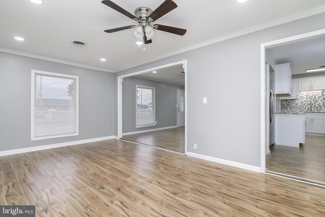 interior space featuring light hardwood / wood-style floors, ceiling fan, and crown molding