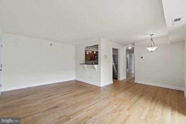 unfurnished living room with light hardwood / wood-style flooring