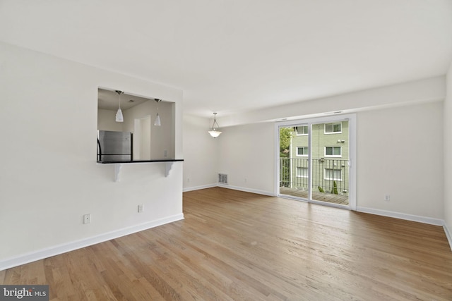 unfurnished living room featuring light hardwood / wood-style flooring