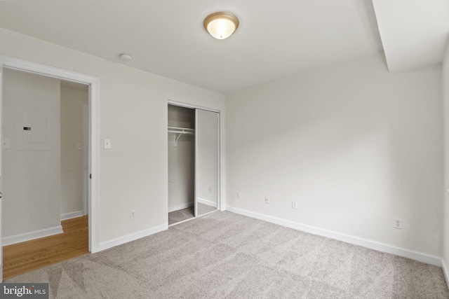 unfurnished bedroom with a closet and carpet