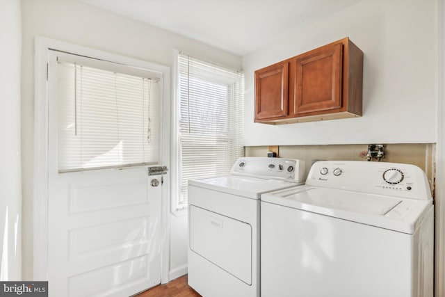 laundry room with cabinets, independent washer and dryer, and light hardwood / wood-style floors