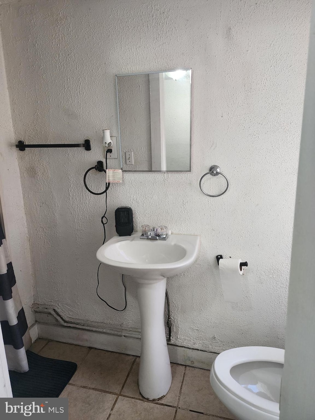 bathroom featuring tile patterned flooring and toilet