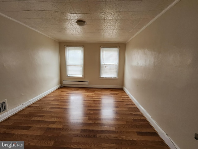 502 Brunswick St, Baltimore, MD 21223 - empty room with baseboard heating, ornamental molding, wood finished floors, and baseboards