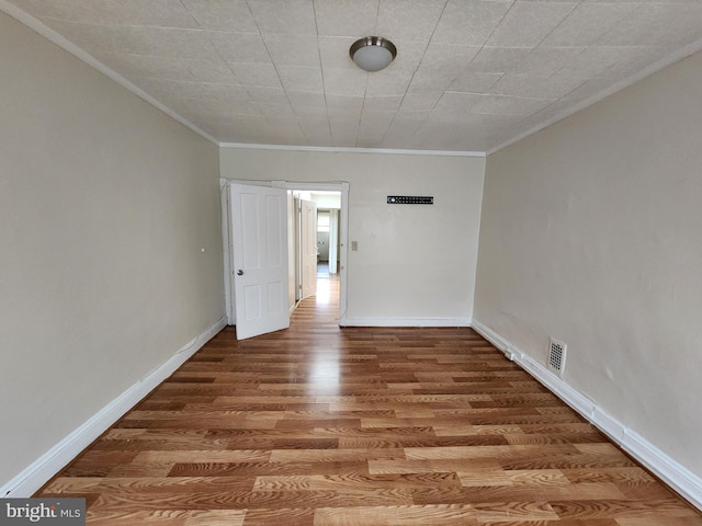 502 Brunswick St, Baltimore, MD 21223 - spare room with ornamental molding, wood finished floors, and baseboards