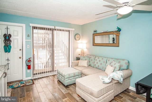 living room with ceiling fan, hardwood / wood-style floors, and a textured ceiling