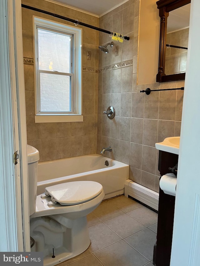 full bathroom with a baseboard radiator, tile patterned flooring, toilet, tile walls, and tiled shower / bath