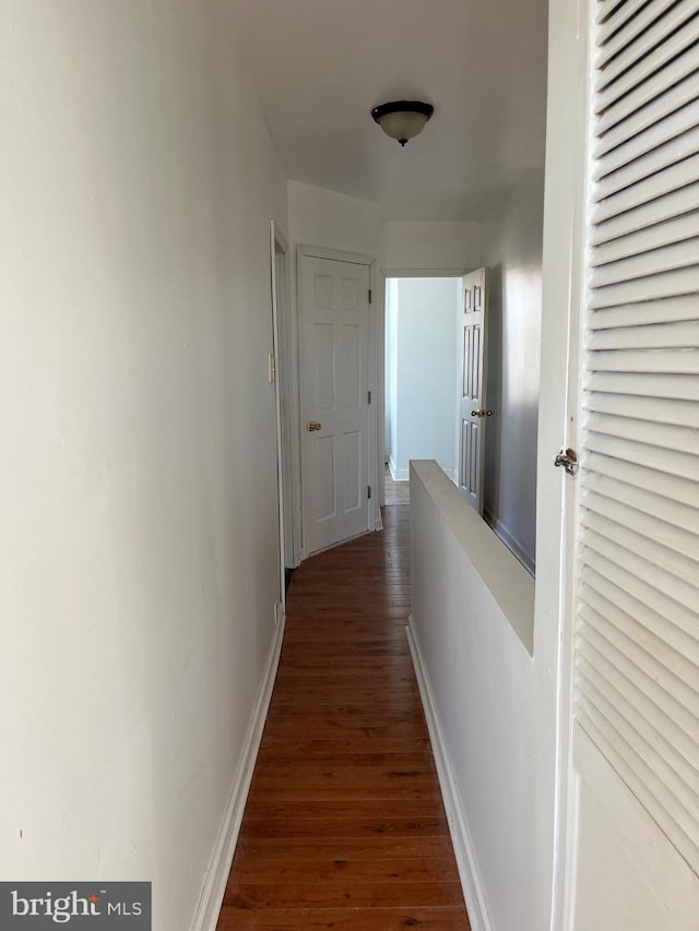 hall with dark hardwood / wood-style floors