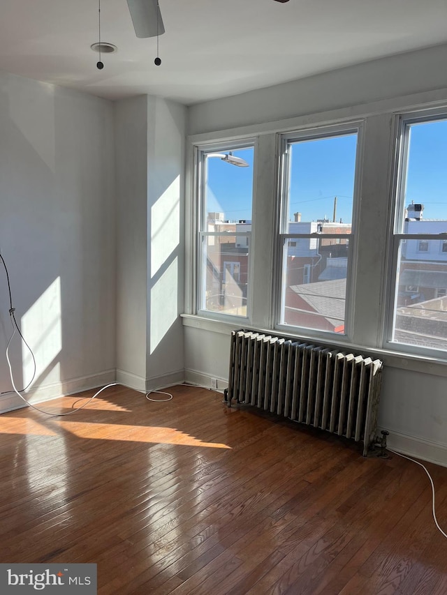 3358 Livingston St, Philadelphia, PA 19134 - spare room with radiator heating unit, hardwood / wood-style flooring, plenty of natural light, and baseboards
