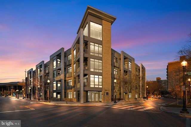 view of outdoor building at dusk