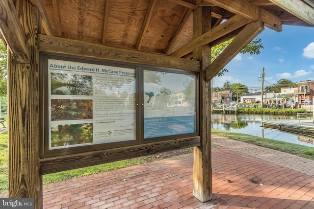 wooden deck with a water view and a dock