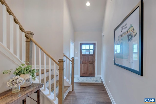 entryway featuring hardwood / wood-style floors and high vaulted ceiling