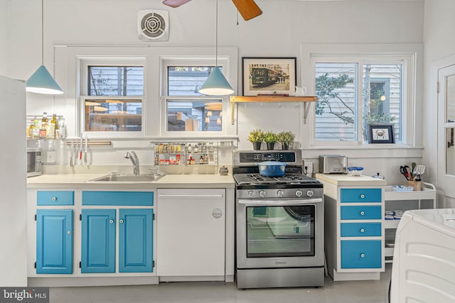 kitchen featuring blue cabinetry, decorative light fixtures, sink, and appliances with stainless steel finishes