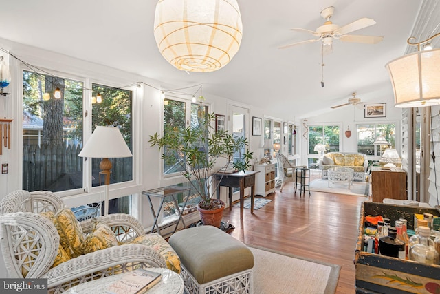 sunroom / solarium with ceiling fan and vaulted ceiling