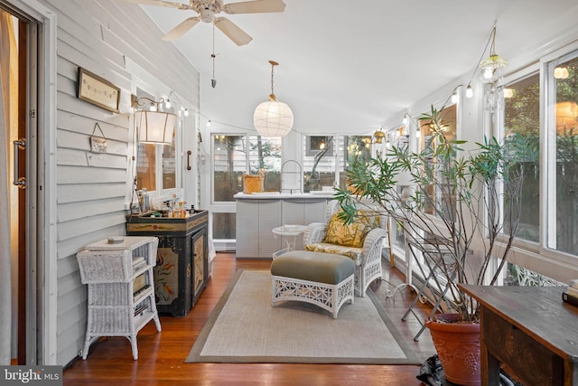 sitting room featuring a healthy amount of sunlight, ceiling fan, and wood-type flooring