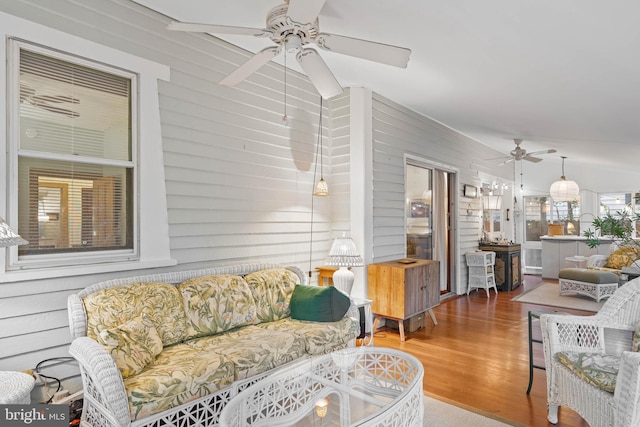 living room with wood walls and hardwood / wood-style flooring