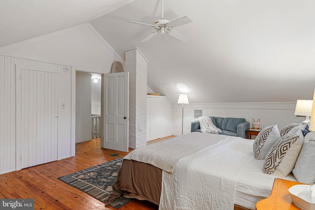 bedroom with ceiling fan, light hardwood / wood-style floors, and lofted ceiling