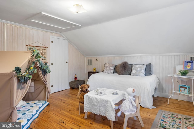 bedroom featuring light wood-type flooring and lofted ceiling