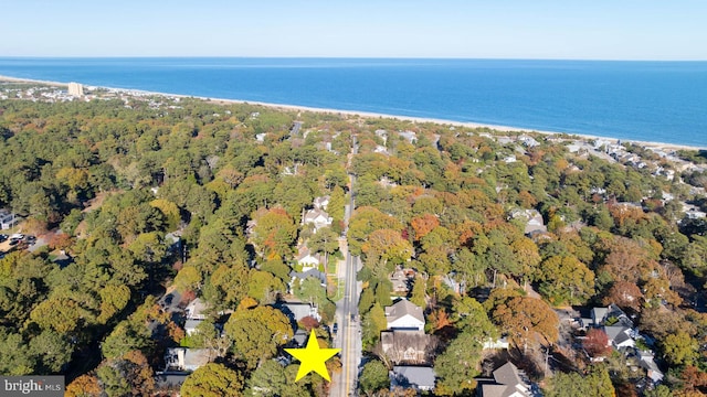 birds eye view of property with a water view and a view of the beach