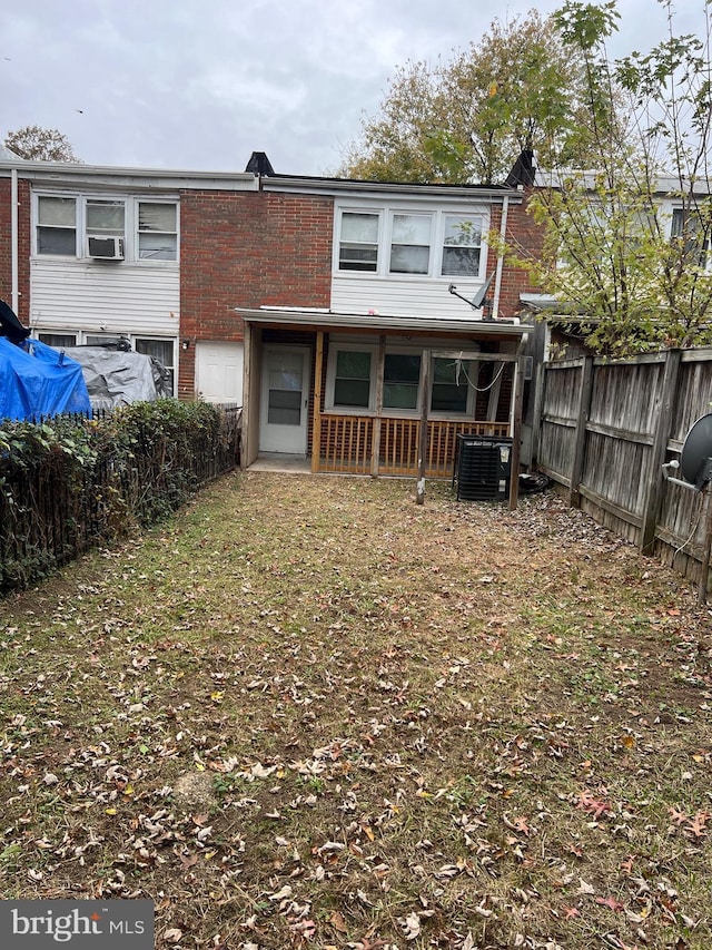 back of property featuring central AC