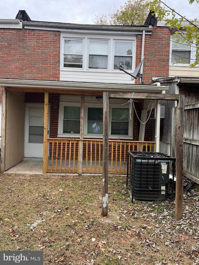 rear view of house featuring central AC unit