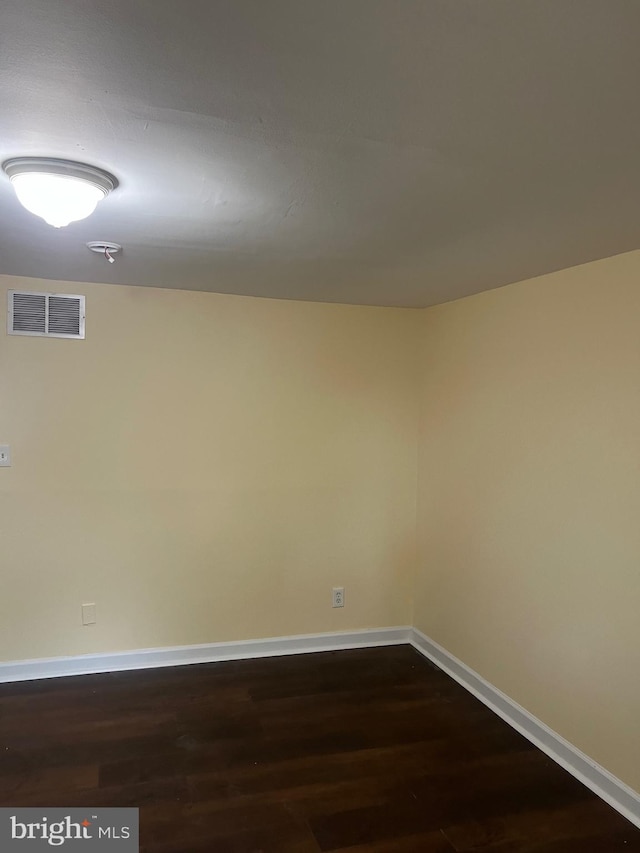 empty room featuring dark hardwood / wood-style flooring