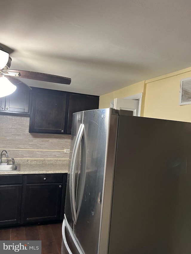 kitchen with stainless steel fridge, dark hardwood / wood-style flooring, backsplash, and sink