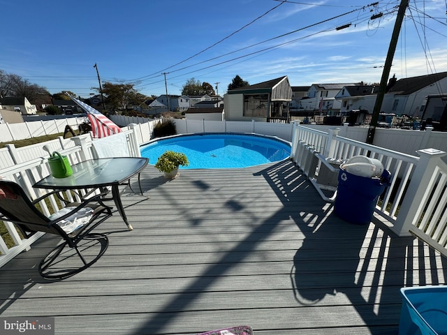 view of swimming pool with a wooden deck