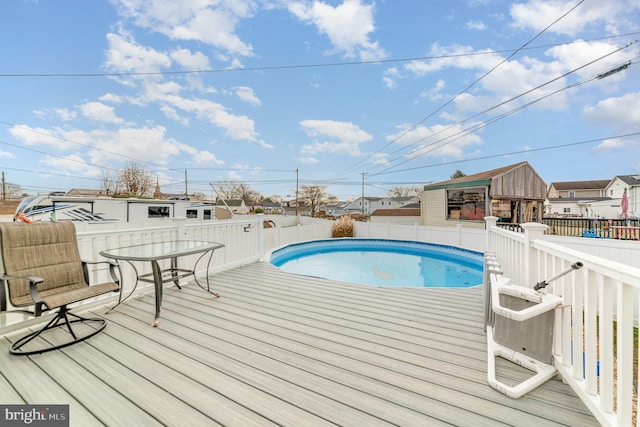 view of swimming pool featuring a wooden deck