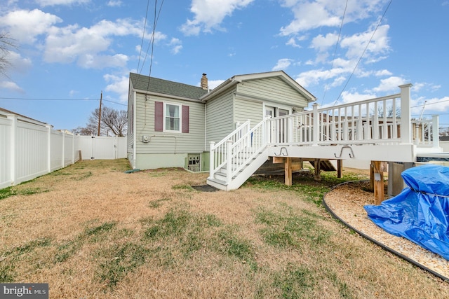 back of house with a yard and a wooden deck