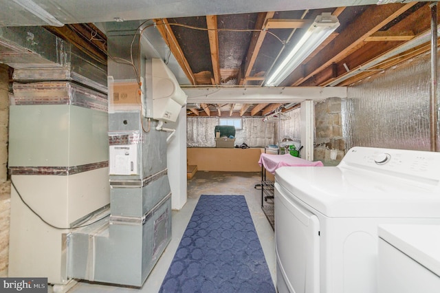 laundry area featuring heating unit and washer and clothes dryer