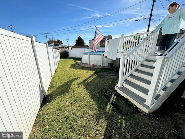 view of yard with a pool side deck