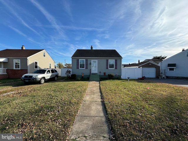 bungalow featuring a front lawn and a garage