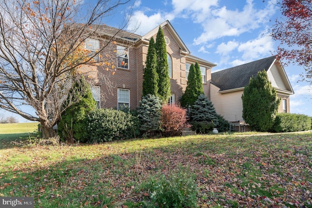 view of property exterior with a lawn