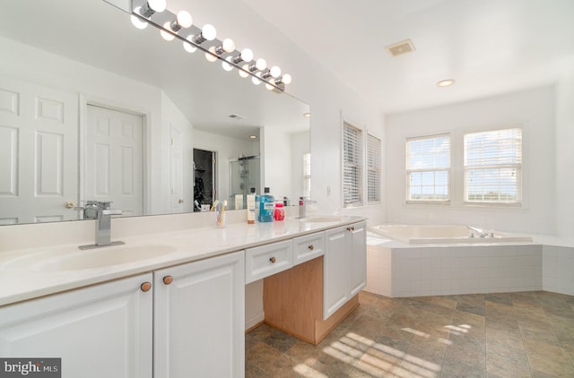 bathroom with plus walk in shower and vanity