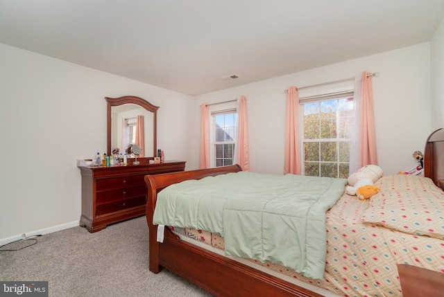 bedroom featuring light colored carpet