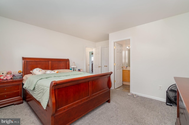 carpeted bedroom featuring connected bathroom