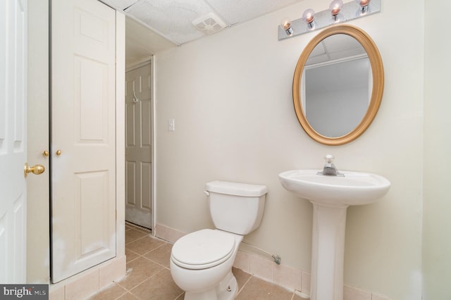 bathroom featuring tile patterned flooring and toilet