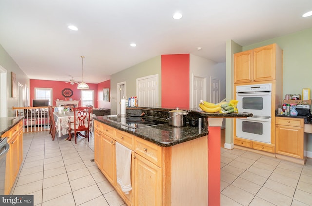 kitchen featuring light brown cabinets, white double oven, hanging light fixtures, black electric cooktop, and light tile patterned flooring