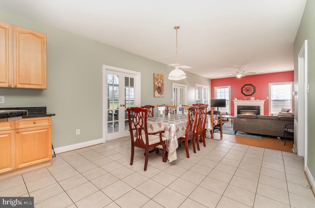 dining area with ceiling fan, light tile patterned floors, and french doors