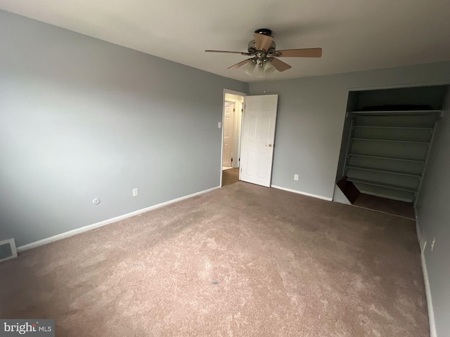 unfurnished bedroom featuring a closet, ceiling fan, and dark carpet