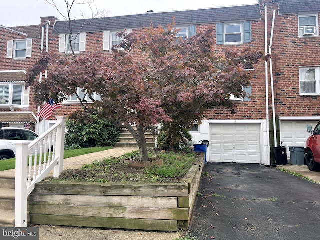 view of property with a garage and cooling unit