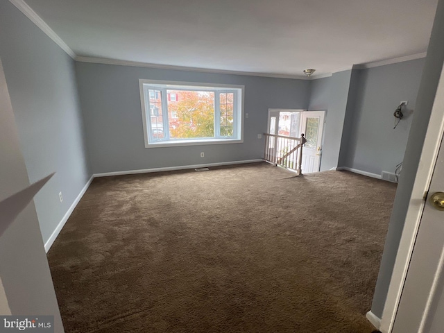 carpeted empty room with a wealth of natural light and crown molding