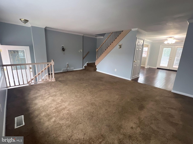 carpeted empty room with french doors, ceiling fan, and crown molding